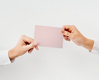 Hands holding a white card