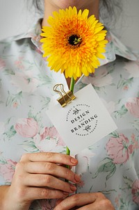 Woman with a yellow gerbera daisy with a card mockup