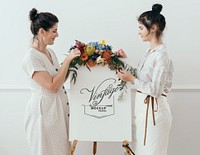 Women standing by a floral vintage frame mockup