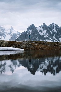 Woman standing by Lac Cheserys overlooking the Mont Blanc massif