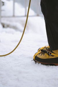 Woman with a rope wearing yellow trekking boots