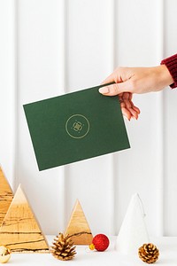 Greeting card in front of a paper Christmas tree