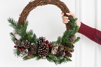 Woman holding a fresh Christmas wreath