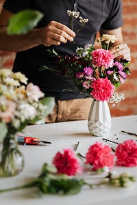Man putting flowers in a vase