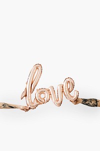 Hands holding a glossy rose gold love balloon mockup