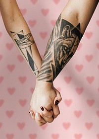 Couples holding hands against a pink background