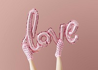 Love glossy pink foil balloon on pink background