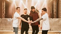 Music band joining hands, concert photo
