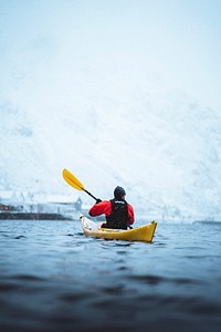 Woman paddling a kayak in Lofoten, Norway