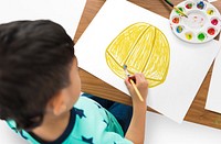 Child with a drawing of engineer safety helmet