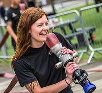 Woman holding water hose, June 1, 2019, Cheshire, UK. Original public domain image from Flickr