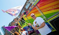 Man waving flag at pride parade, August 24, 2019, Manchester, UK. Original public domain image from Flickr