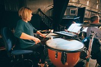 Woman playing timpani, October 15, 2019, UK. Original public domain image from Flickr