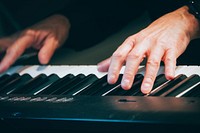 Hands playing piano. Original public domain image from Flickr