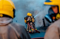 Fireman with fire hose. Original public domain image from Flickr