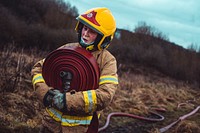 Female firefighter, hose relay training, January 28, 2021, Cheshire, UK. Original public domain image from Flickr