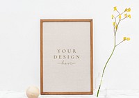 Photo frame mockup by a yellow forsythia