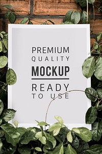 White poster mockup surrounded by leaves