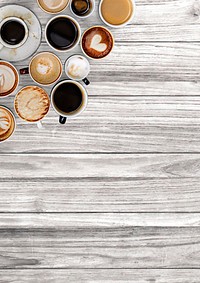 Various coffee cups on a gray wooden textured panel<br /> 