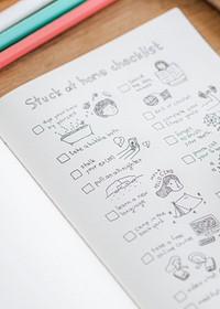 Social isolation doodle style checklist in a notebook