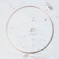 Round gold frame on weathered white paint textured background vector