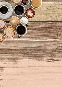 Mixed coffee cups on a pastel pink and brown wooden panel