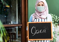 Muslim woman in face mask with sign mockup during new normal