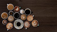 Coffee mugs on a dark brown wooden textured wallpaper