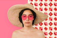 Bare chested woman wearing a big round hat and red vintage heart-shaped sunglasses psd