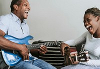 Father and daughter playing guitar