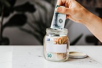 Saving money in jar, financial photo