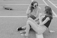 Girls hanging out at car park, gray photo