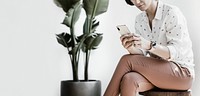 Businesswoman sitting, using mobile phone