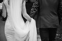 Wedding ceremony, bride & groom holding hands, black & white photo
