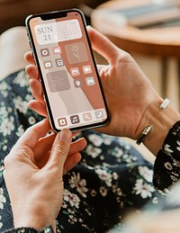 Phone screen mockup psd with hand holding in aesthetic beige widgets