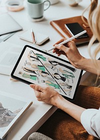 Fashion designer drawing on tablet