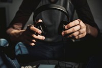 Man holding headphones, music photo