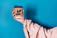 Holding disposable cup mockup psd