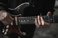 Man playing electric guitar, music performance photo