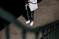 Man in jeans, white sneakers and canvas tote bag