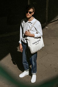 Casual man with eco tote bag mockup