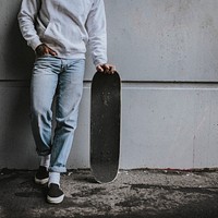 Male skateboarder in sweater, jeans