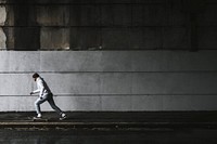 Man skateboarding under a bridge