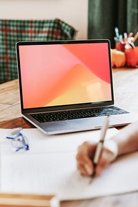 Gradient wallpaper on laptop screen and study table