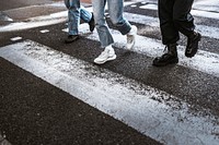 People wearing sneakers, crossing road