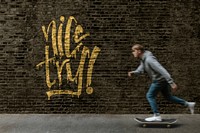 Brick wall mockup psd with a man skating past