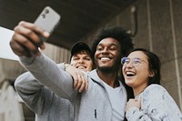 Diverse friends taking selfies with phone