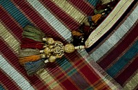 Square of finely striped black and white silk material with heavy striped borders at each end of red, green, gold and silver. Finished at both ends with a fringe of small tassels and with larger tassels at each corner.. Original from the Minneapolis Institute of Art.