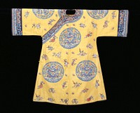 Imperial robe of yellow k'ossu with eight large medallions, each containing a 5-clawed dragon in blue grasping the Heavenly Jewel. Beneath the dragon waves and the sacred mountain, and surrounding trim tight clouds, bats, and swastikas. In the spaces between the medallions embroidered Buddhist and Taoist symbols, bats, and swastikas. Colors in medallions are shades of blue, red, olive green, soft violet, and coral. Colors of the embroidered motifs, worked in satin, laid and outline stitch, are shades of green, red, pink, blue, and brown, mauve and grey. Wide sleeves with band of dark blue k'ossu with Universe design edged with a strip of plain gold k'ossu. Collar of same. Coat slit at sides, and bound around front, bottom, and openings with black satin. Lining of yellow satin damask of medallion design. Inscription in front and at back of neck. Perhaps a woman's coat. K'ossu very firm.. Original from the Minneapolis Institute of Art.