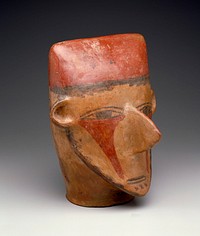 Large head with wide flattened brow and painted face. The enormous, thin nose, ears, and pointed chin are in full relief. The mouth is a narrow slit with black lips; the almond shaped eyes and thin eyebrows are painted. A triangular area, extending from beneath the eyes to the chin on each side of the nose, is painted red. Cheeks edged with black paint, possibly representing a beard. Wavy vertical lines of black on back of skull represent hair, as does the line of black across the forehead. The figure wears a brick red skullcap. Surface highly burnished. The size of this example makes it an important one. Schoeler says: early Nazca--MWS.. Original from the Minneapolis Institute of Art.